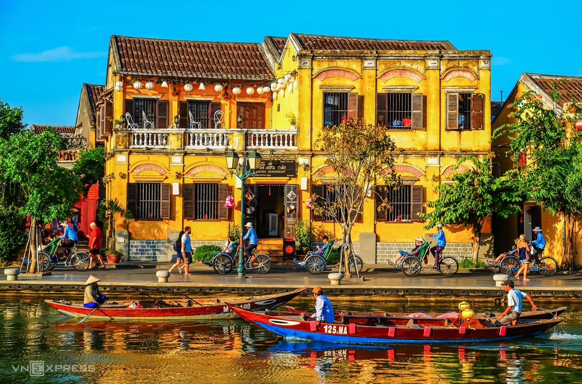 Golden sunlight illuminates the preserved architecture and vibrant streets of Hoi An’s world-famous ancient town.