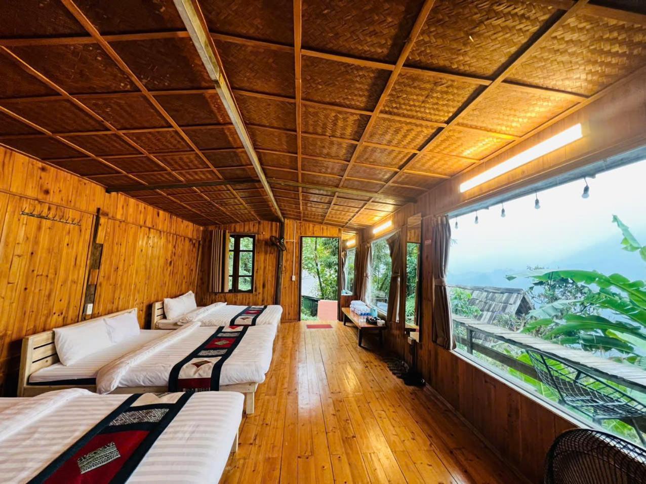 Cozy bedroom with a valley view of Hmong Catcat Homestay.