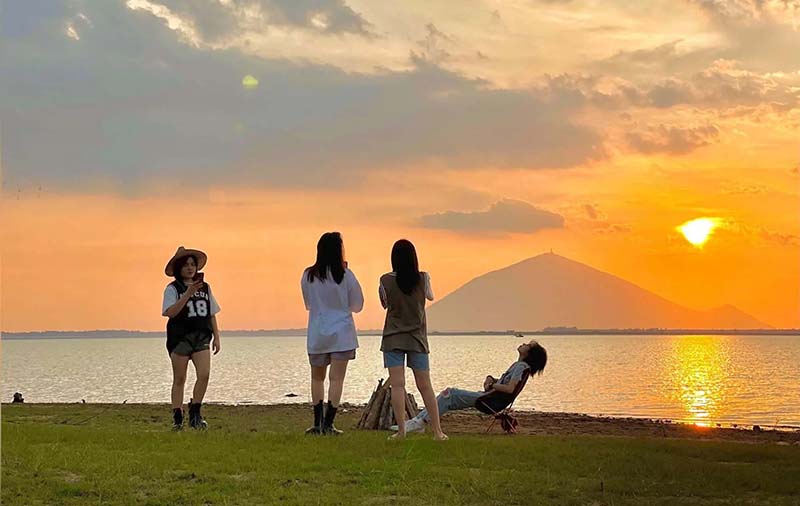Du khách ngắm hoàng hôn bên bờ hồ Dầu Tiếng