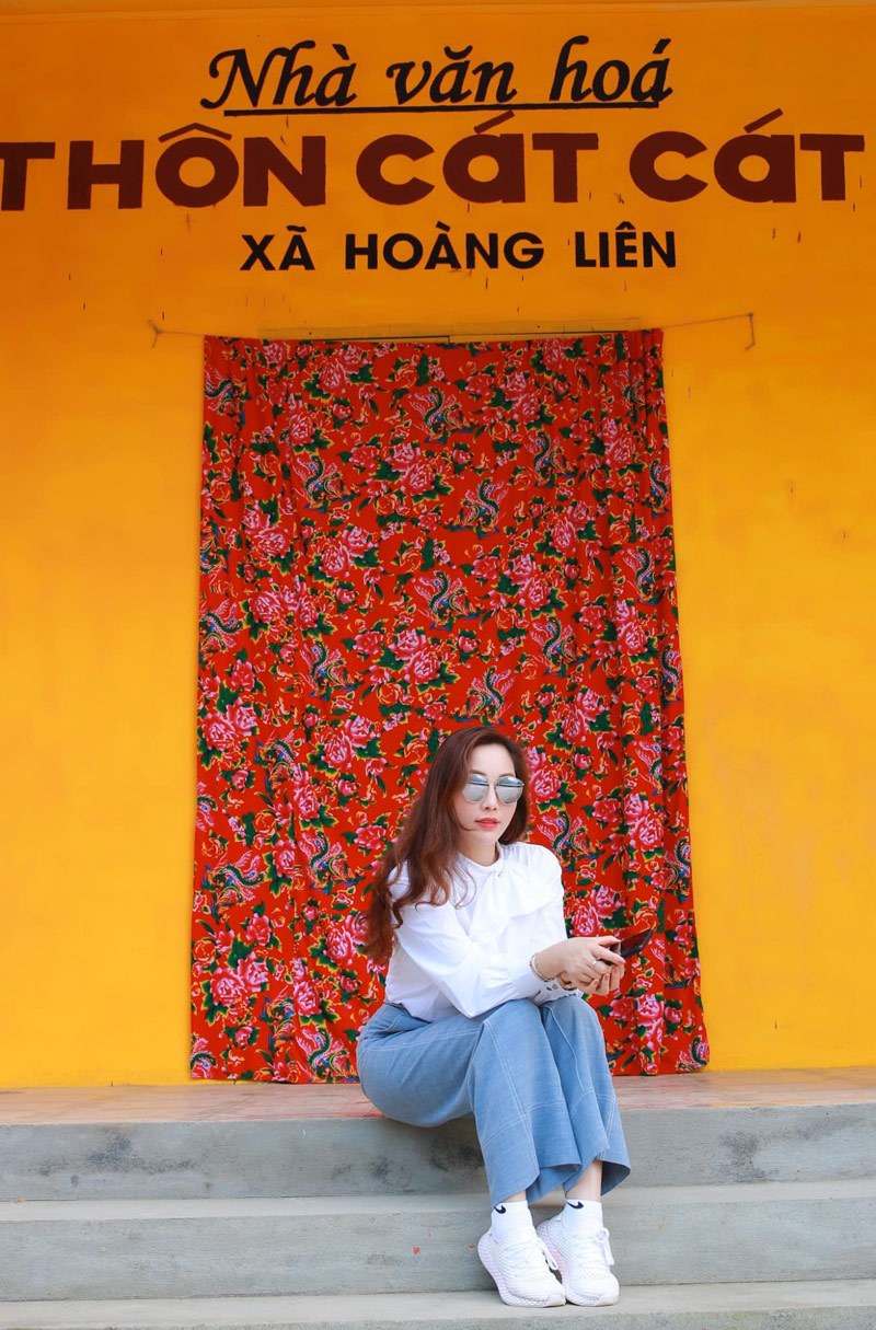 Sắc vàng của bức tường nhà văn hóa làm nổi bật bức ảnh của du khách