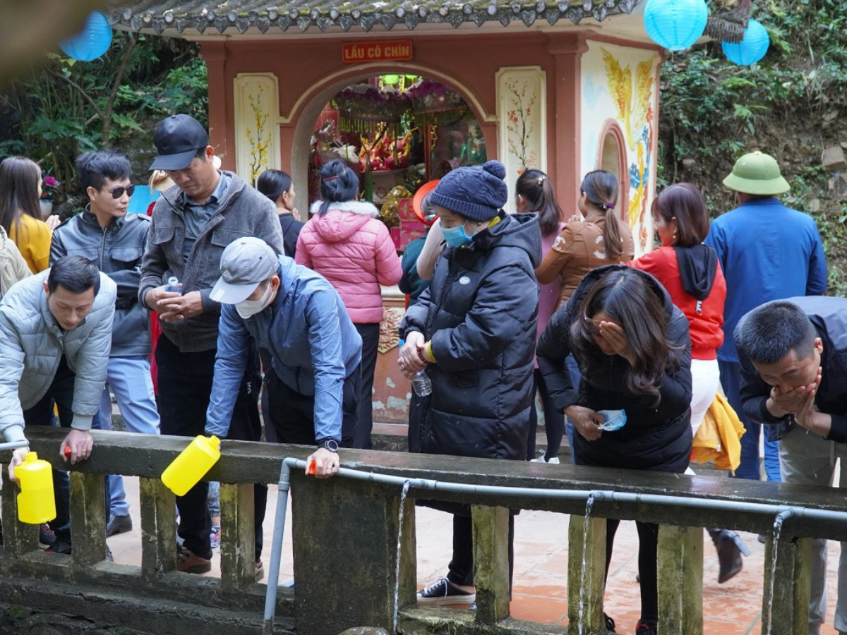 Nhiều du khách mang theo chai hoặc can thủy tinh để lấy "nước thánh" Phủ Na.