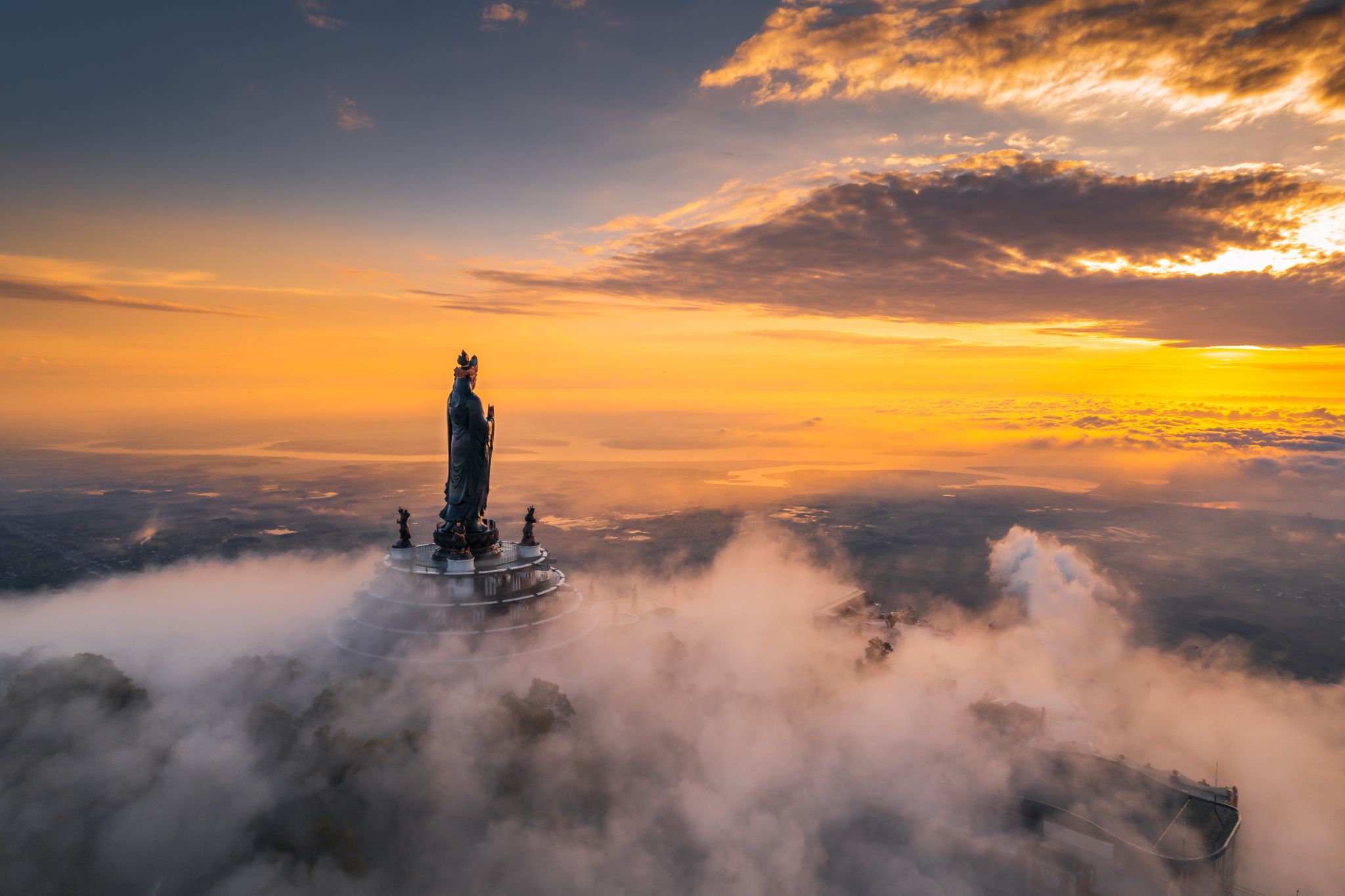A spectacular sea of clouds blankets the summit of Ba Den Mountain