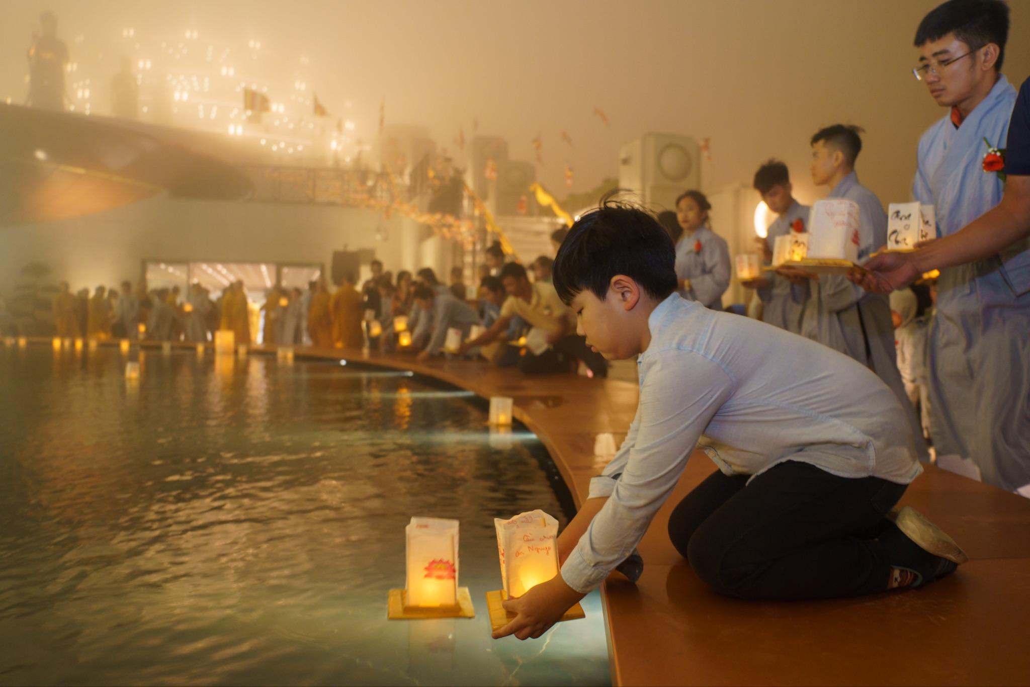 Visitors reverently releasing lanterns on the summit of Ba Den Mountain.